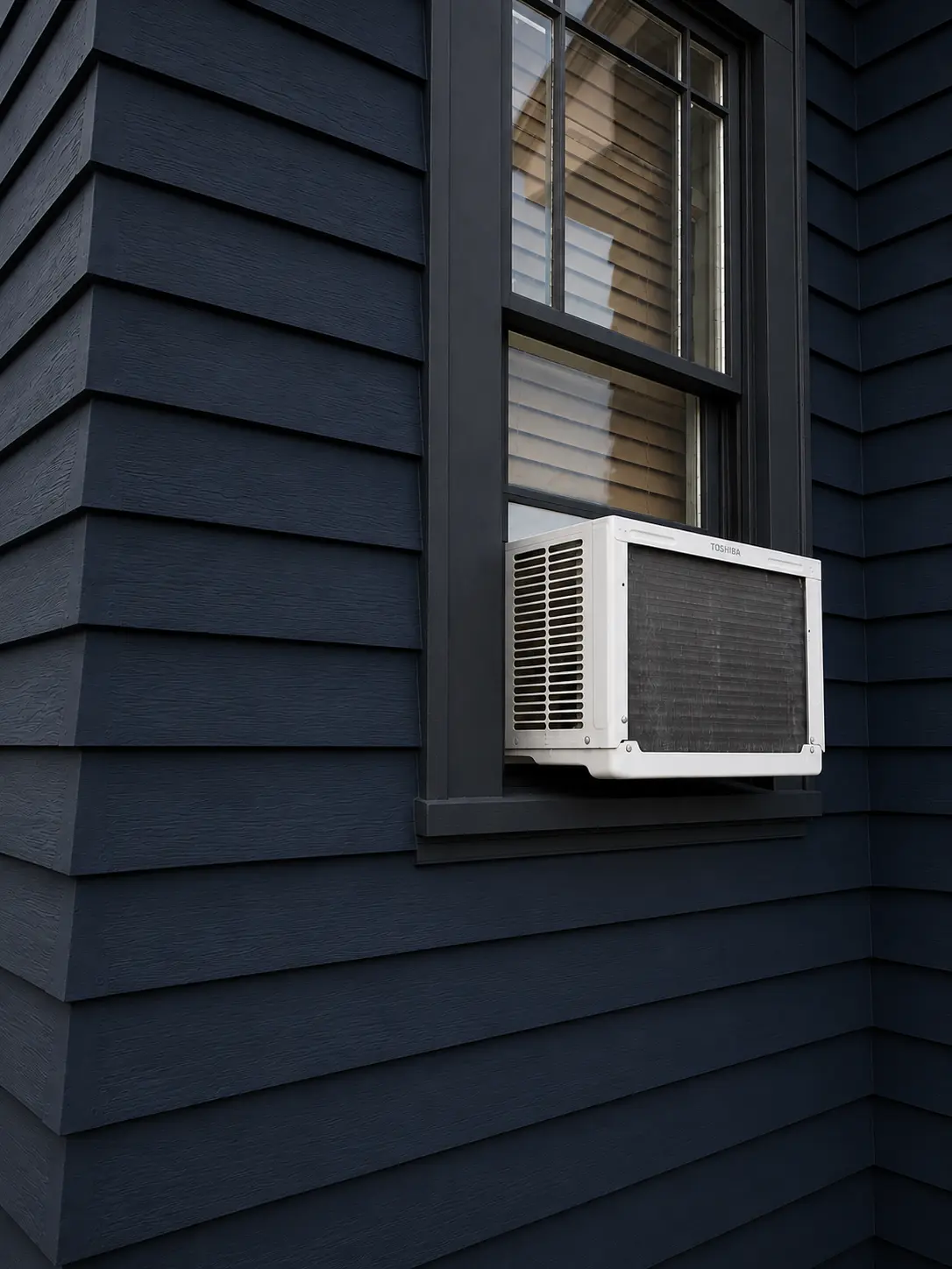 Finished siding and window assembly with precise dark trim.
