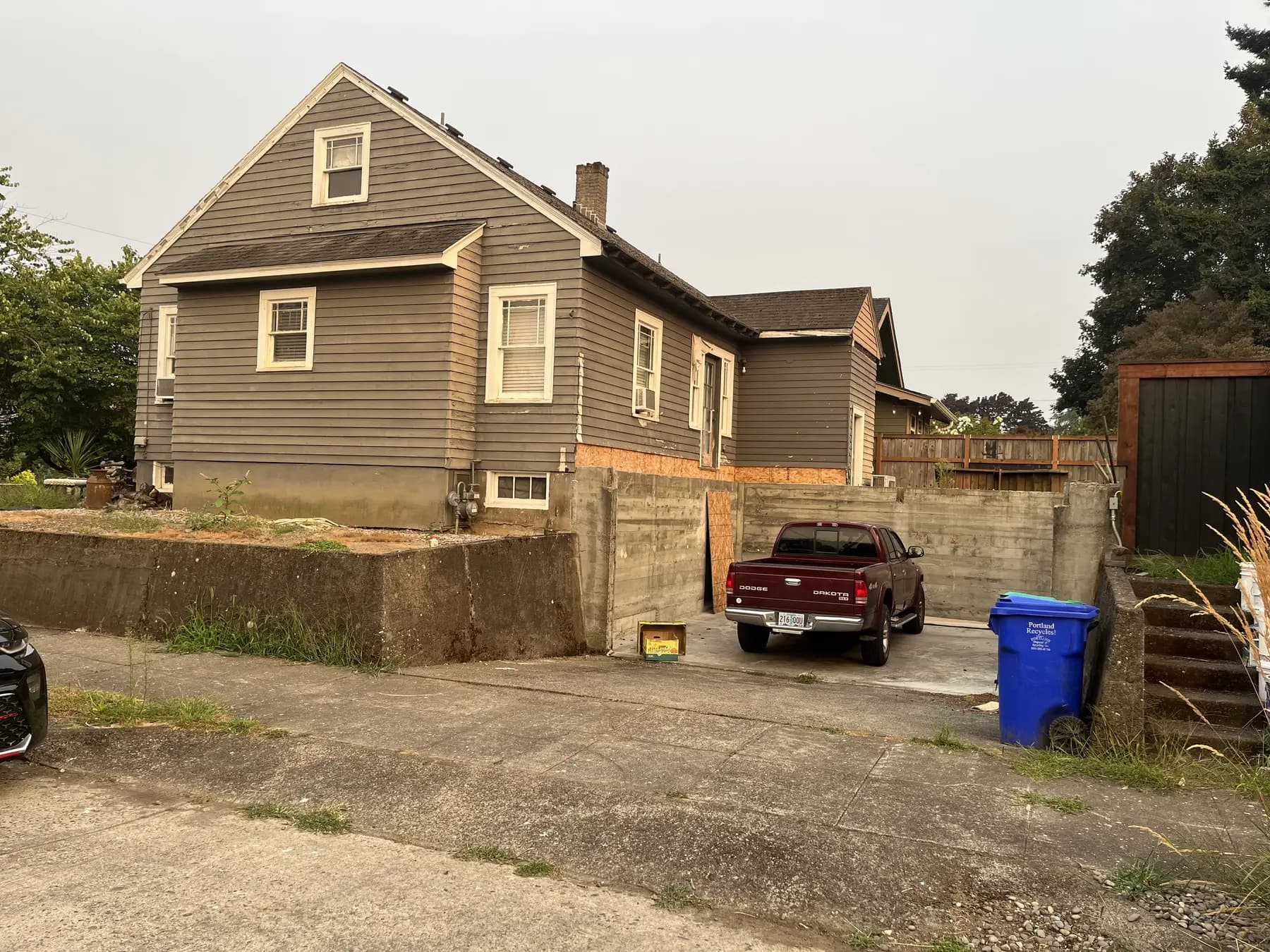 Rear and side of the home before exterior restoration and construction.