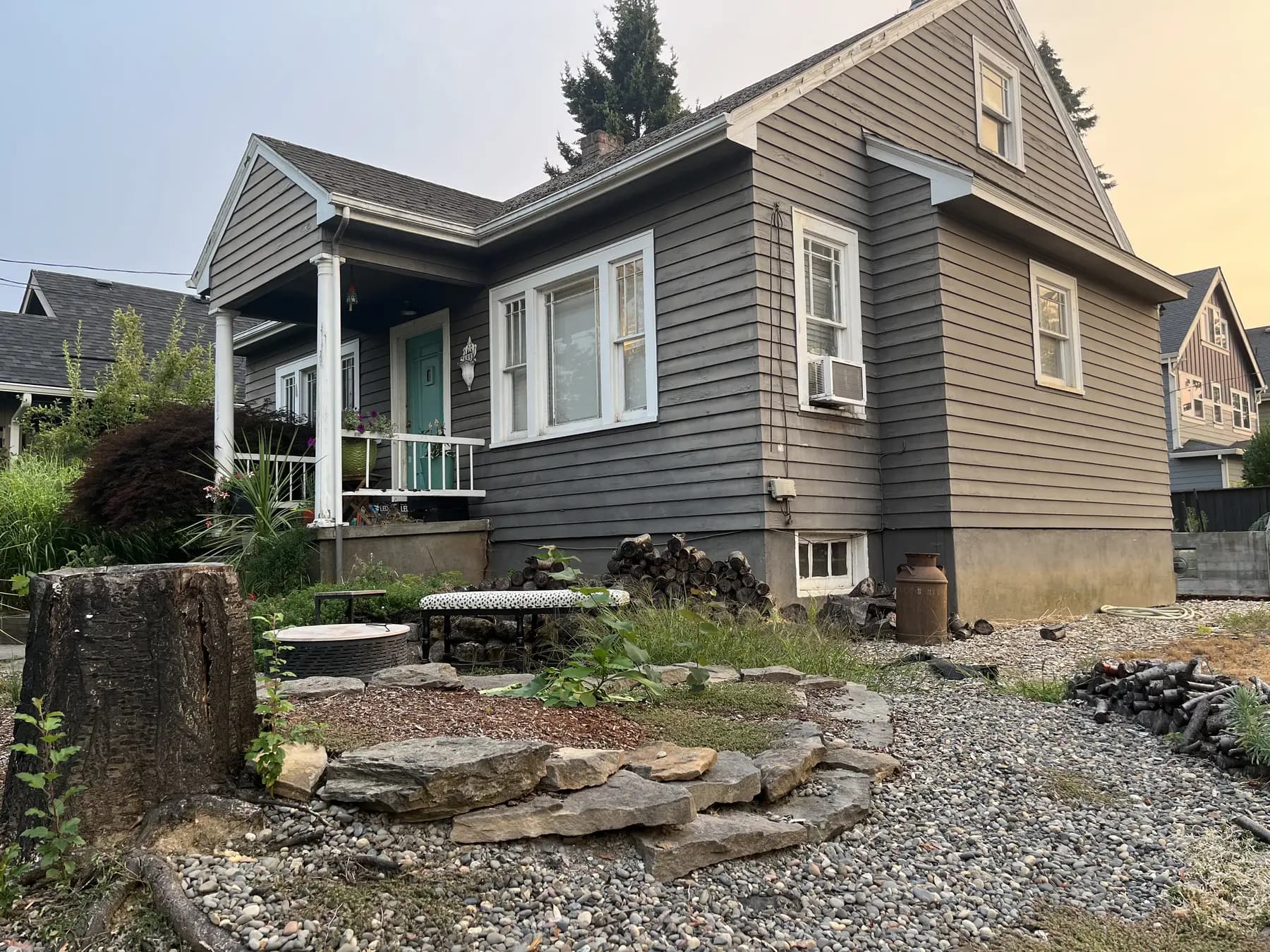 Side elevation with weathered gray siding and white trim before painting.